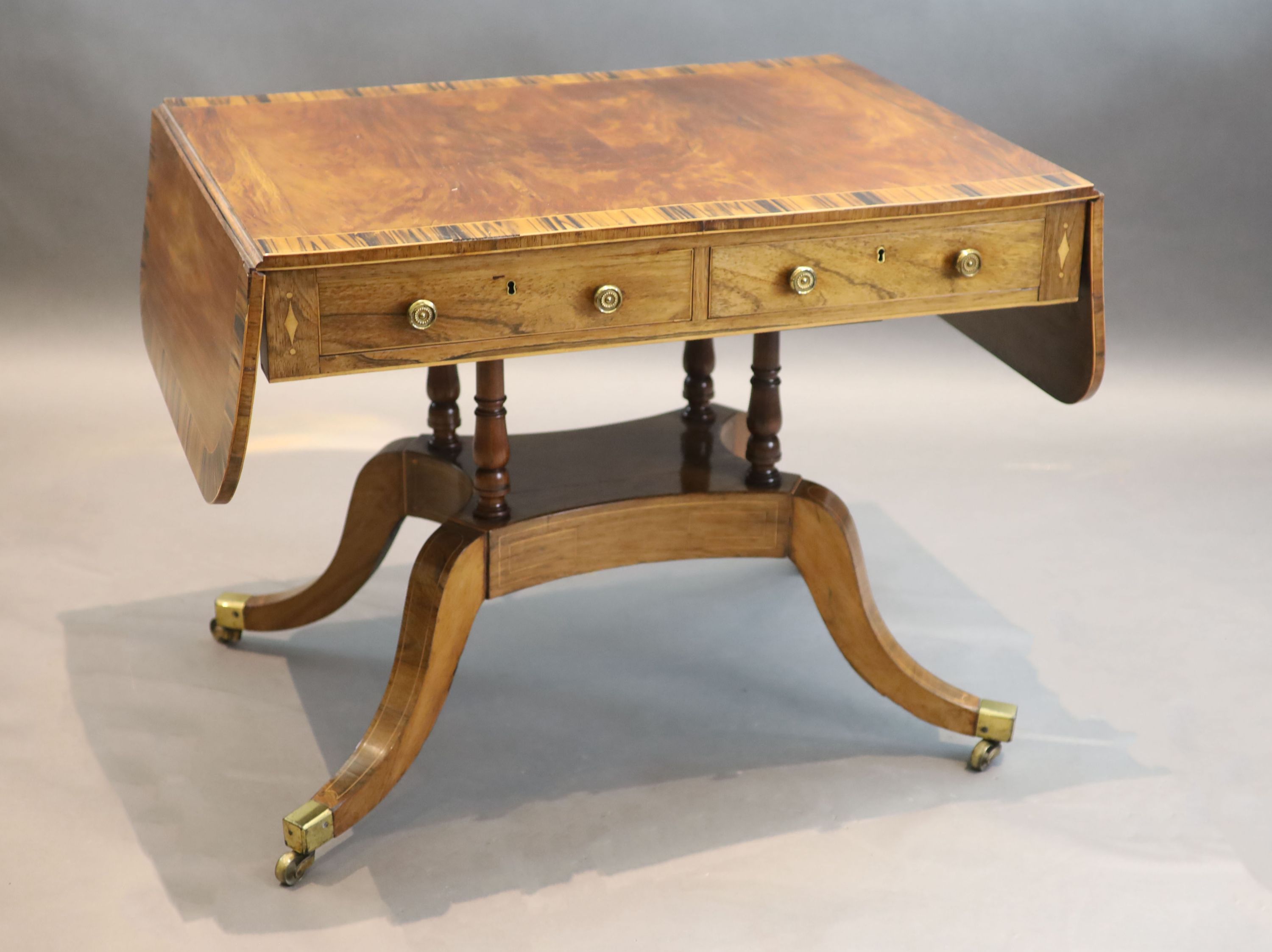 A Regency mahogany sofa table banded in coromandel, W. 3ft. D. 2ft. 2in. H. 2ft 4in.